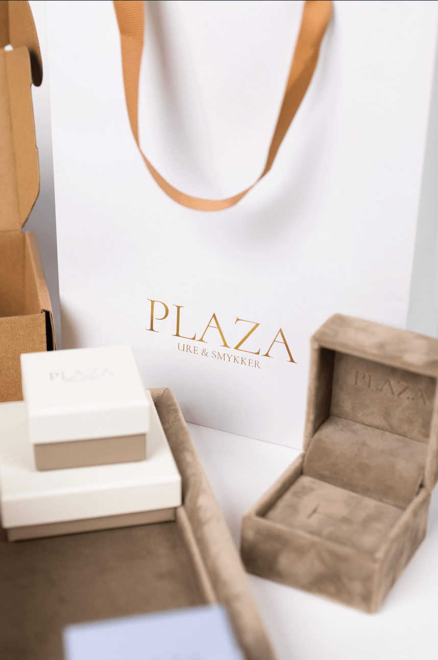 Cream jewellery gift boxes with satin ribbons in soft natural light